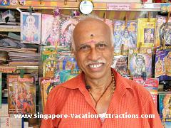 A warm and friendly smile of a stall holder in Little India selling magazine, news paper, books etc that were imported from India